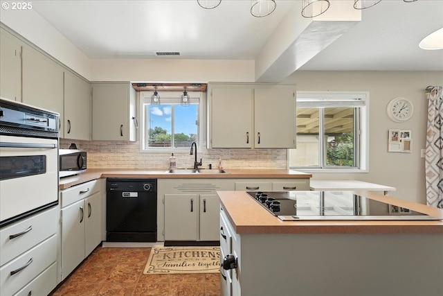 3002 17th Ave, Forest Grove, OR 97116 - kitchen featuring black appliances, backsplash, and a kitchen island