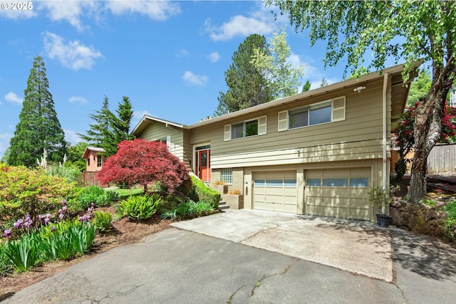 split foyer home featuring driveway and a garage