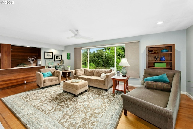 living area with wood finished floors, ceiling fan, baseboards, and recessed lighting
