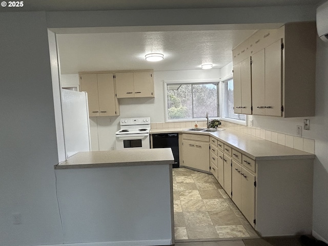 kitchen with a textured ceiling, white appliances, a sink, light countertops, and cream cabinetry