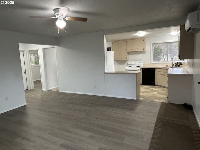 kitchen featuring white appliances, wood finished floors, a wall mounted air conditioner, light countertops, and a sink