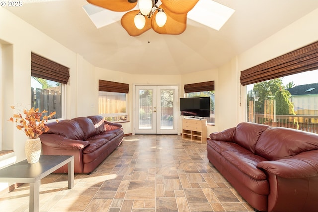 12015 SE Regal Ct, Clackamas, OR 97015 - living room featuring ceiling fan, a skylight, french doors, and stone finish floors