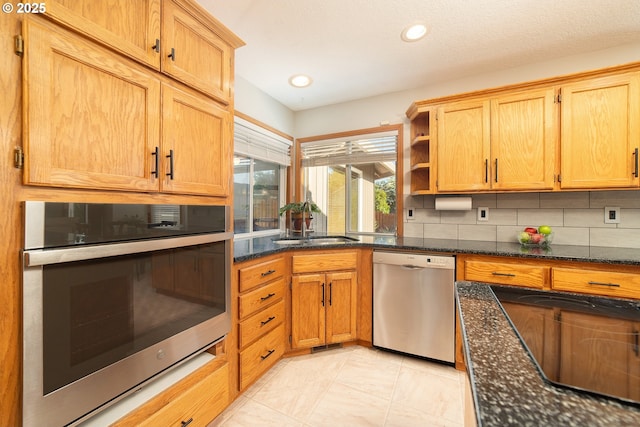 12015 SE Regal Ct, Clackamas, OR 97015 - kitchen with appliances with stainless steel finishes, tasteful backsplash, open shelves, dark stone counters, and light tile patterned floors
