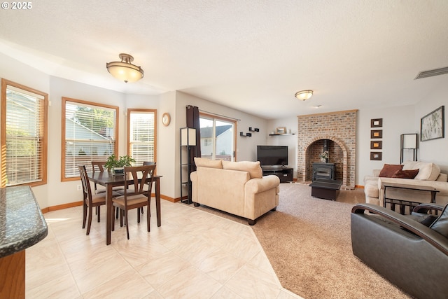 12015 SE Regal Ct, Clackamas, OR 97015 - living room featuring a wood stove and a textured ceiling