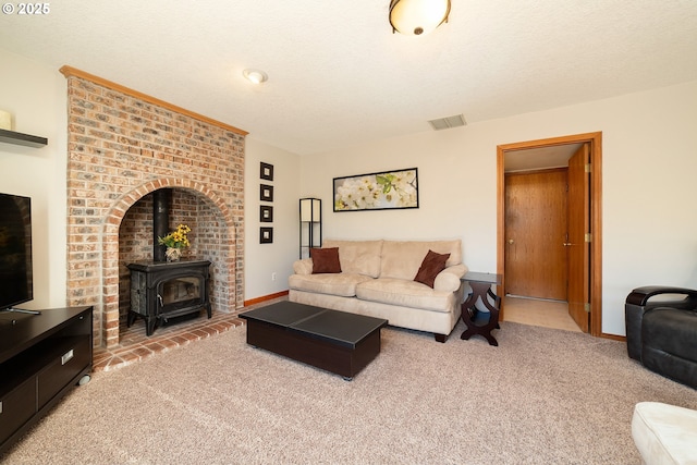 12015 SE Regal Ct, Clackamas, OR 97015 - carpeted living room featuring a wood stove and baseboards