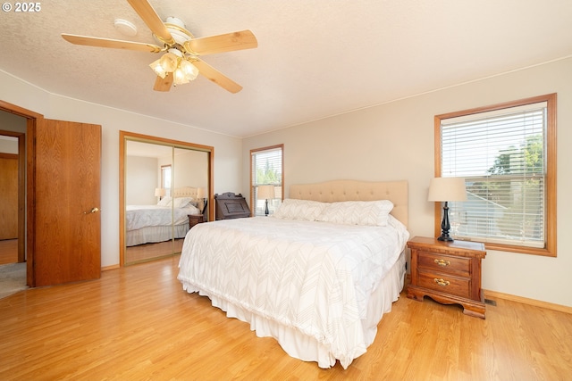 12015 SE Regal Ct, Clackamas, OR 97015 - bedroom with light wood-type flooring, a closet, and a ceiling fan