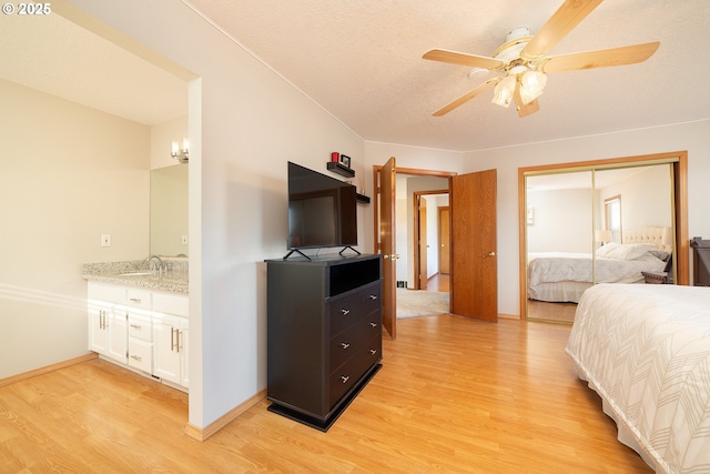 12015 SE Regal Ct, Clackamas, OR 97015 - bedroom with light wood-style flooring, a closet, and ceiling fan