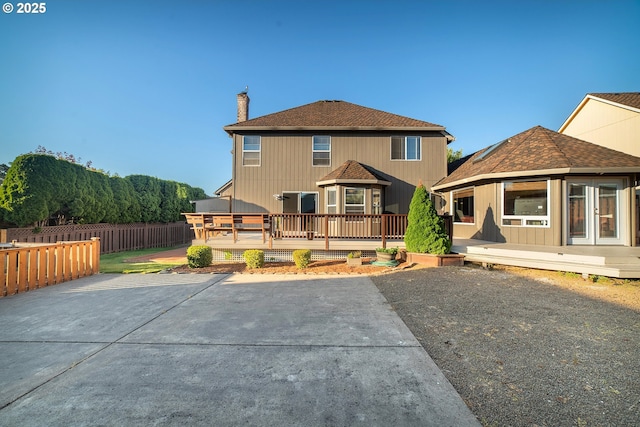 12015 SE Regal Ct, Clackamas, OR 97015 - rear view of property with a wooden deck, a chimney, a patio area, and roof with shingles