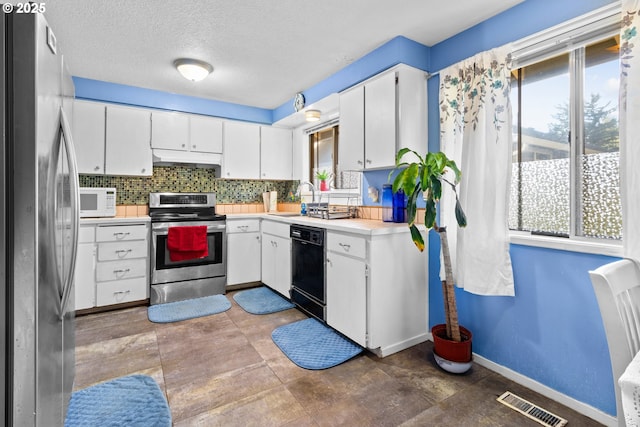 kitchen featuring decorative backsplash, sink, white cabinetry, and stainless steel appliances