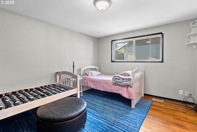 bedroom featuring wood-type flooring