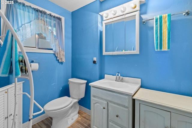 bathroom featuring hardwood / wood-style floors, toilet, and vanity