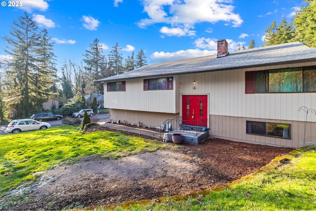 split foyer home with a front lawn