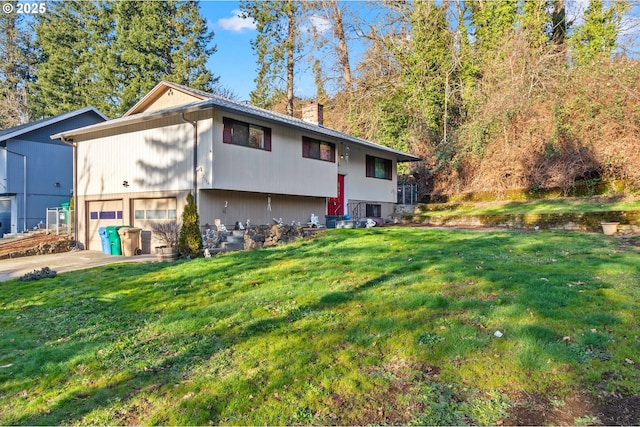 view of front of house with a garage and a front lawn