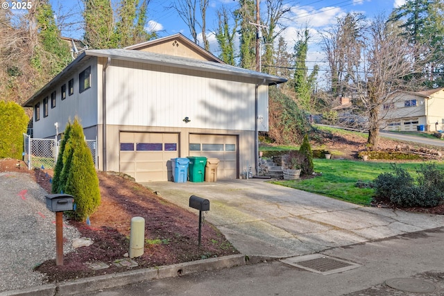 view of property exterior featuring a garage and a yard