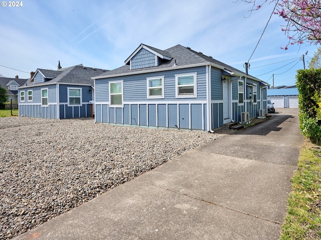 178 S Main St, Lebanon, OR 97355 - view of property exterior featuring roof with shingles, an outbuilding, and board and batten siding