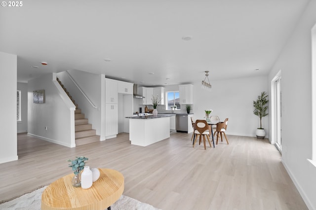 living room with sink and light wood-type flooring