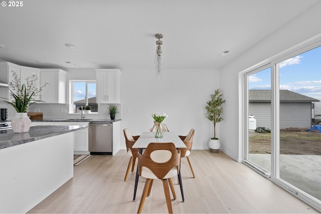 dining room with sink and light hardwood / wood-style floors