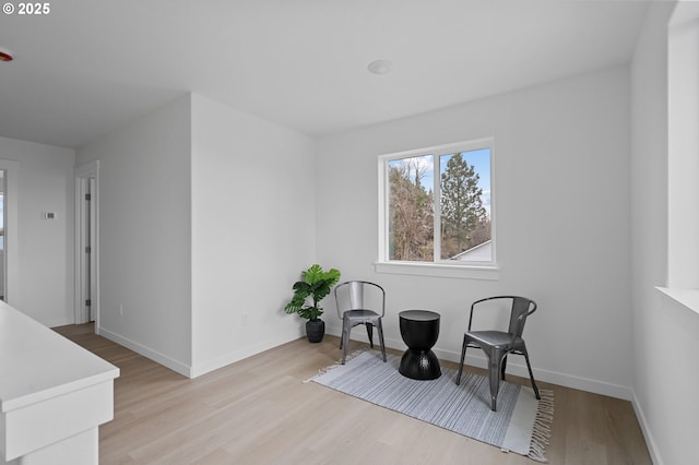 sitting room featuring light hardwood / wood-style floors