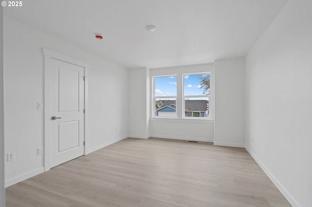 unfurnished room with light wood-type flooring