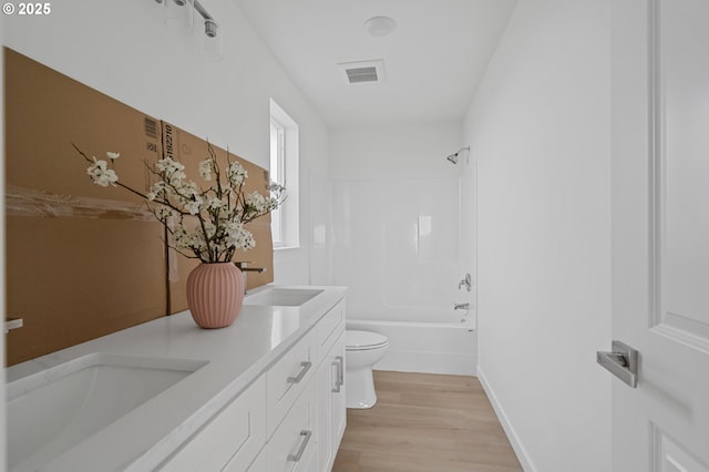 full bathroom featuring vanity, wood-type flooring, tub / shower combination, and toilet