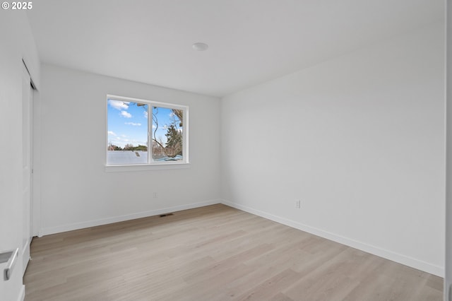 unfurnished room with light hardwood / wood-style floors