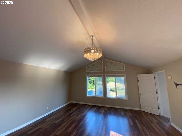 additional living space with dark wood-style floors, baseboards, and a chandelier