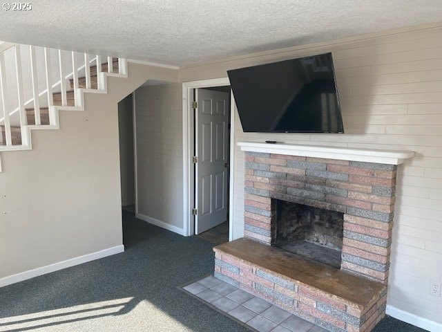 unfurnished living room with a brick fireplace, carpet floors, a textured ceiling, baseboards, and stairway