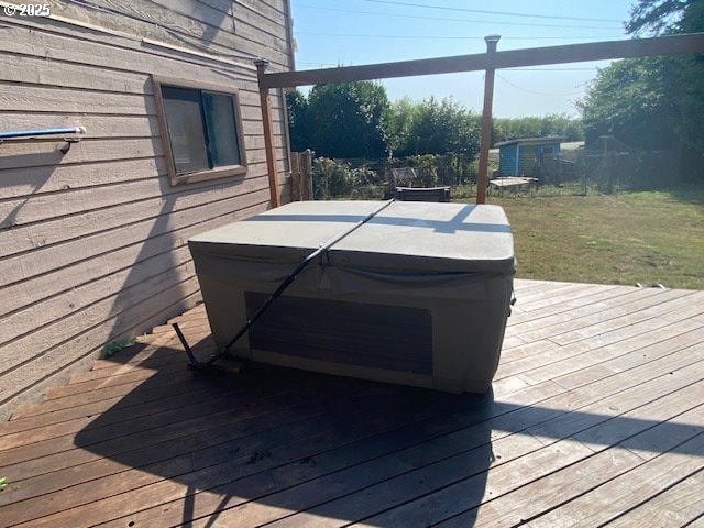 wooden deck featuring a hot tub