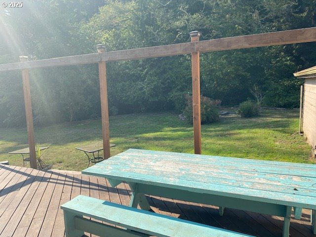 wooden terrace with a lawn