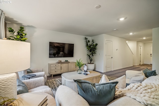 living area with baseboards and recessed lighting