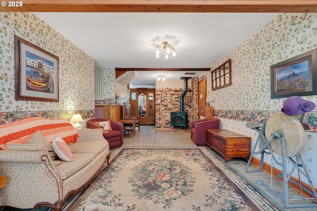 living room featuring a wood stove, wallpapered walls, and visible vents