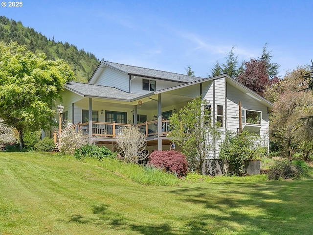 back of property featuring a lawn and a porch