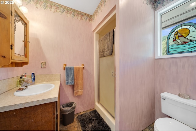 full bath with vanity, toilet, and a stall shower