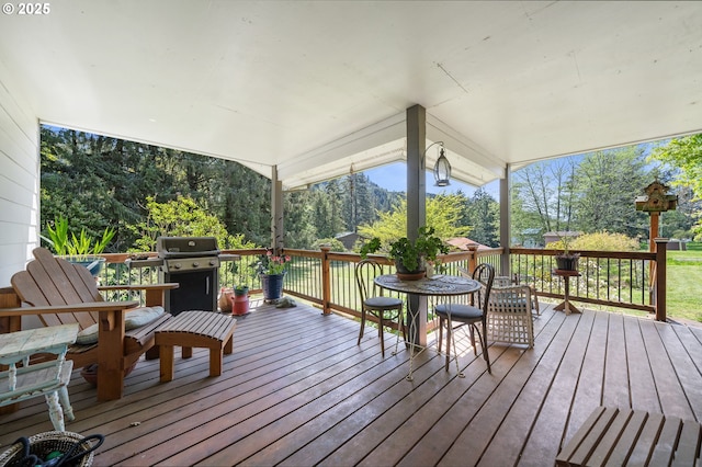 deck featuring area for grilling and outdoor dining space