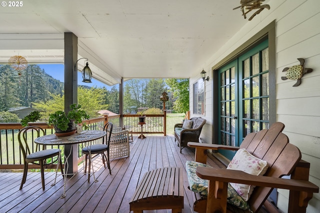 wooden deck with french doors and a porch
