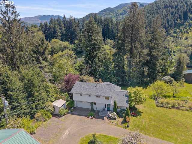 aerial view featuring a view of trees and a mountain view