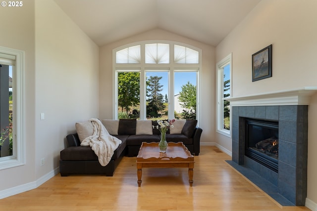 20700 SE Cherry Blossom Ln, Amity, OR 97101 - living area featuring light wood-style flooring, vaulted ceiling, and a tile fireplace