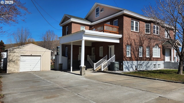 315 N Gale St, Heppner, OR 97836 - view of front facade featuring a balcony, brick siding, an outdoor structure, driveway, and covered porch