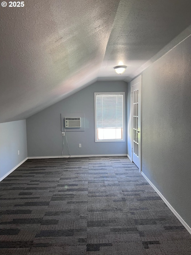 315 N Gale St, Heppner, OR 97836 - additional living space featuring lofted ceiling, dark colored carpet, a wall mounted air conditioner, a textured ceiling, and a textured wall