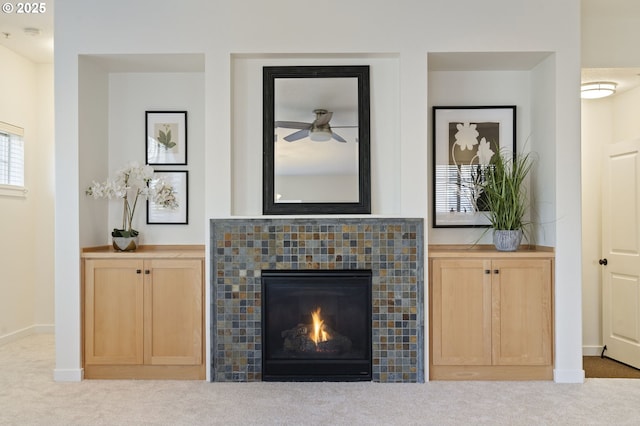 unfurnished living room featuring light carpet and a tiled fireplace