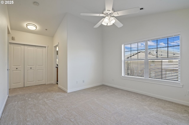 spare room with ceiling fan and light colored carpet