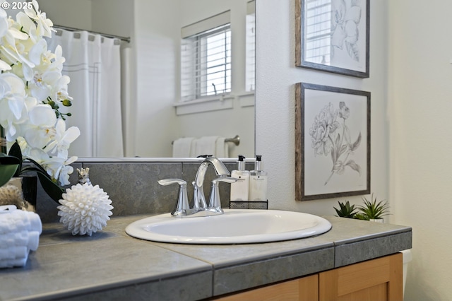 bathroom featuring vanity and backsplash