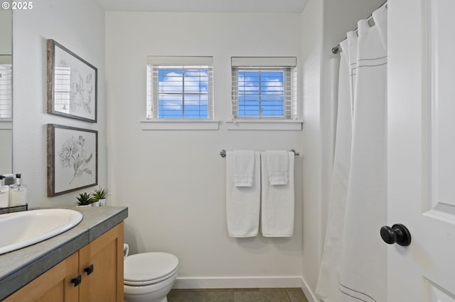 bathroom with vanity, toilet, and tile patterned flooring