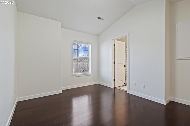 unfurnished room featuring dark hardwood / wood-style flooring and vaulted ceiling