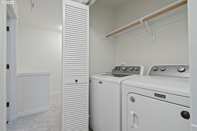 clothes washing area featuring light colored carpet and separate washer and dryer