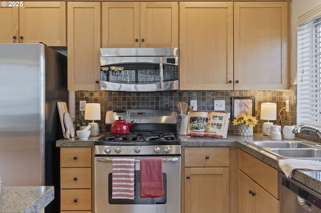 kitchen featuring light brown cabinetry, sink, and stainless steel appliances