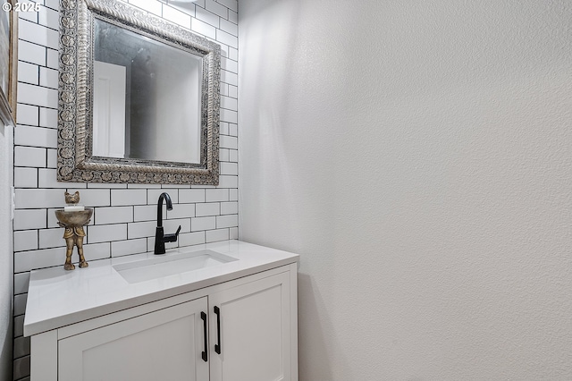 12339 SW Waterford Loop, Wilsonville, OR 97070 - bathroom with tasteful backsplash, vanity, and a textured wall