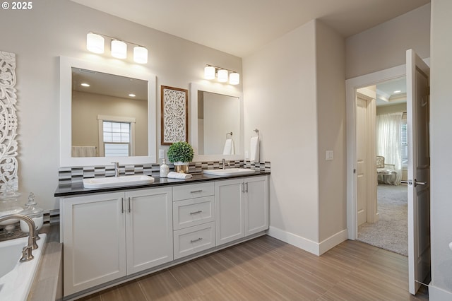 12339 SW Waterford Loop, Wilsonville, OR 97070 - bathroom with double vanity, backsplash, baseboards, and recessed lighting