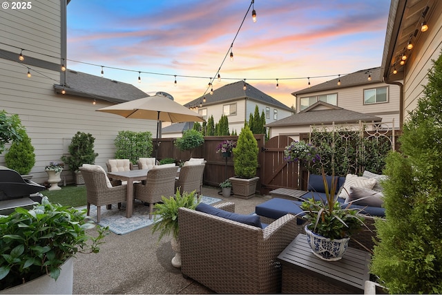 12339 SW Waterford Loop, Wilsonville, OR 97070 - patio terrace at dusk with a patio, a gate, and outdoor dining area