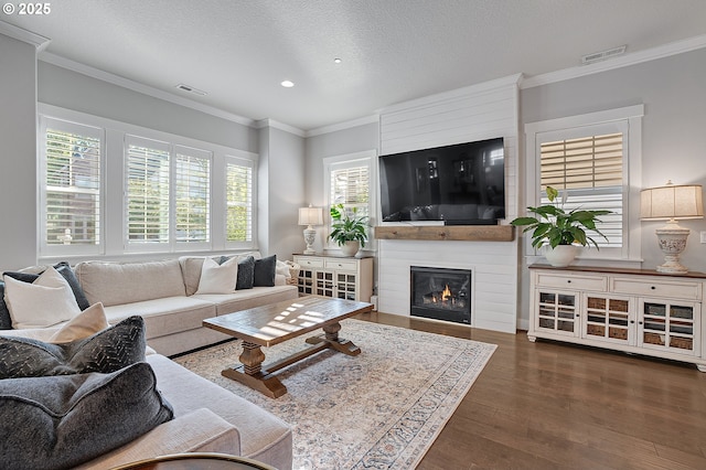 12339 SW Waterford Loop, Wilsonville, OR 97070 - living room featuring crown molding, wood finished floors, a large fireplace, recessed lighting, and a textured ceiling